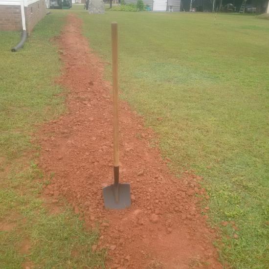 a shovel in a ditch that I hand-dug and filled in, because I'm not afraid of hard work!